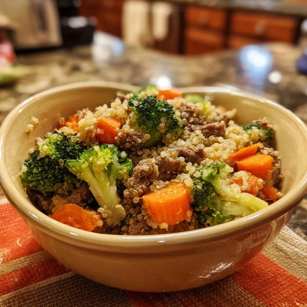 Hearty ground beef & quinoa bowl featuring a close-up view of fluffy quinoa, tender beef, and vibrant broccoli florets.